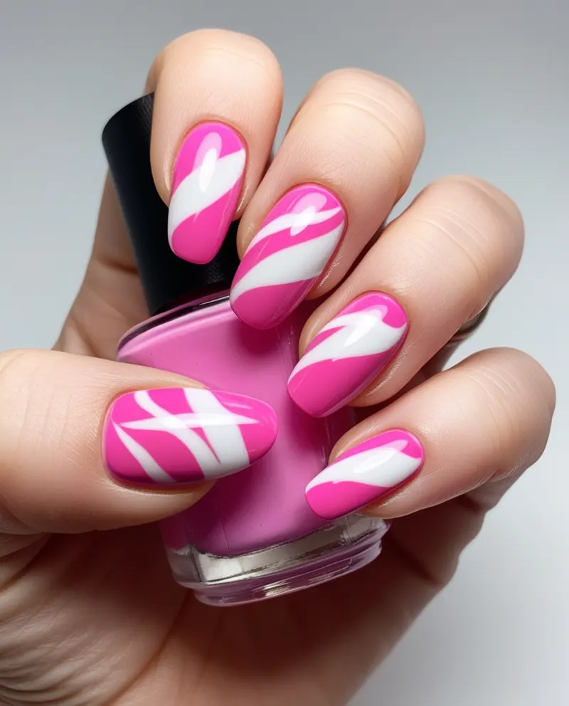 Pink and white nails featuring elegant swirls, stripes, and clean designs.