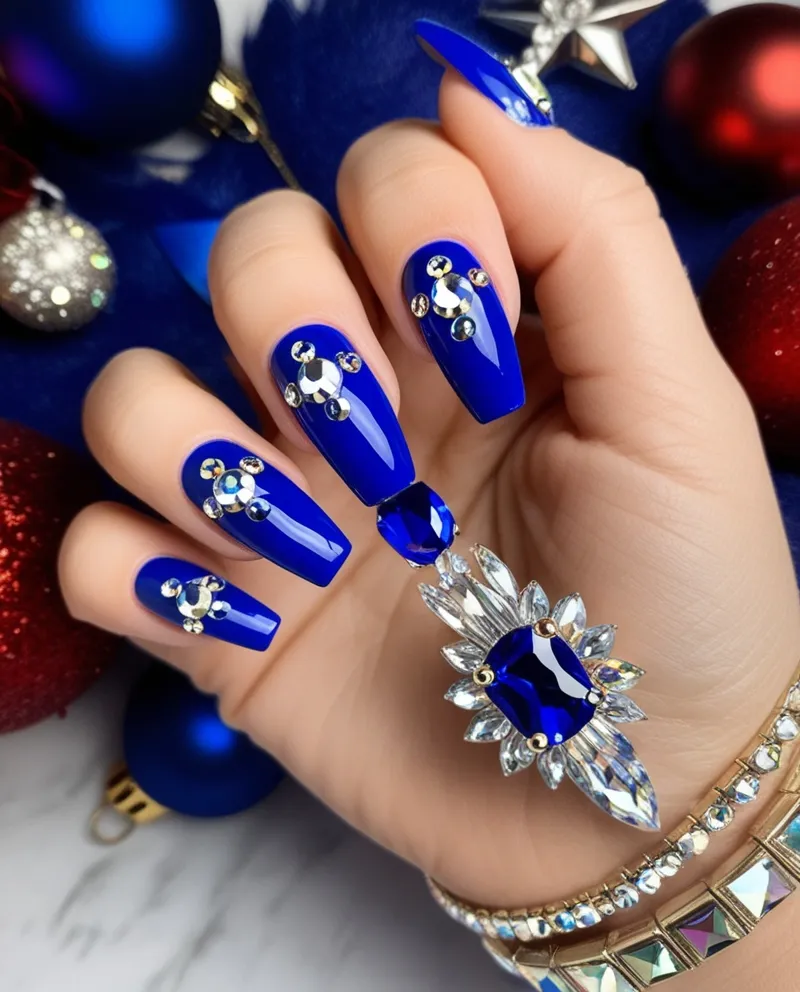 Royal blue nails with rhinestone accents, a shiny and elegant Blue Christmas Nails option.