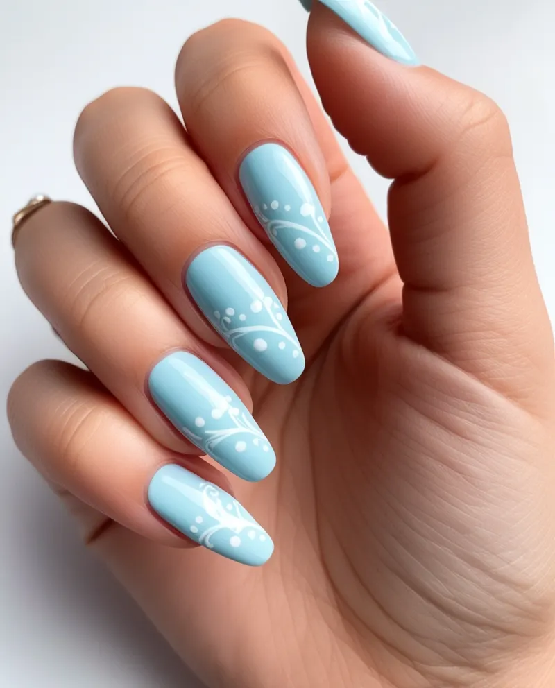 Pastel blue nails with white accents for a soft and elegant look.