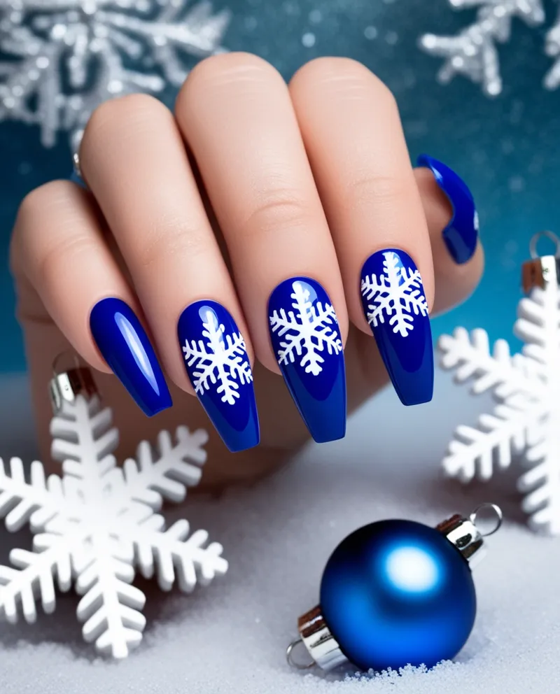 Blue nails with white snowflake designs, a classic Blue Christmas Nails look.