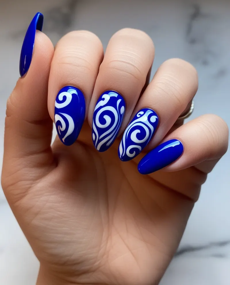 Blue nails with creative swirls for a unique Valentine’s style.