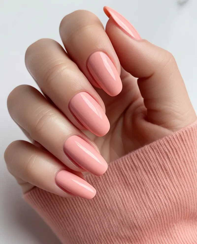 Fresh peach pink nails with a soft, elegant finish perfect for summer.