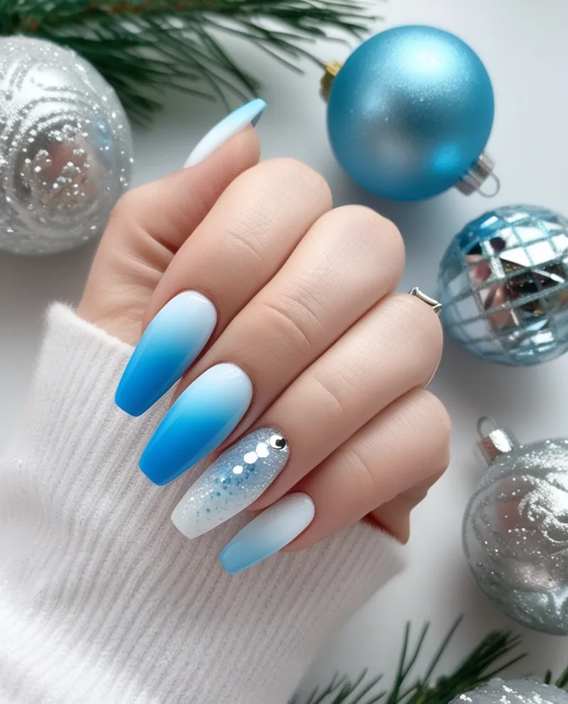 Frosty blue ombré nails with glitter, a sparkling Blue Christmas Nails style.