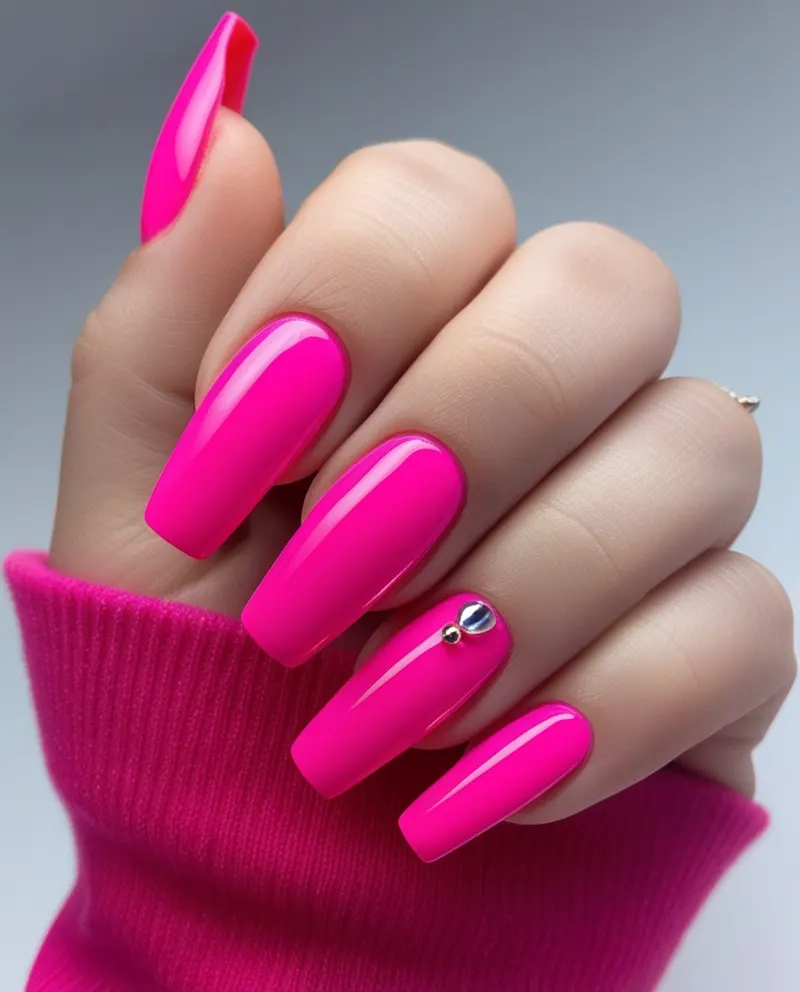 Vibrant Barbie pink nails with a shiny and bold appearance.