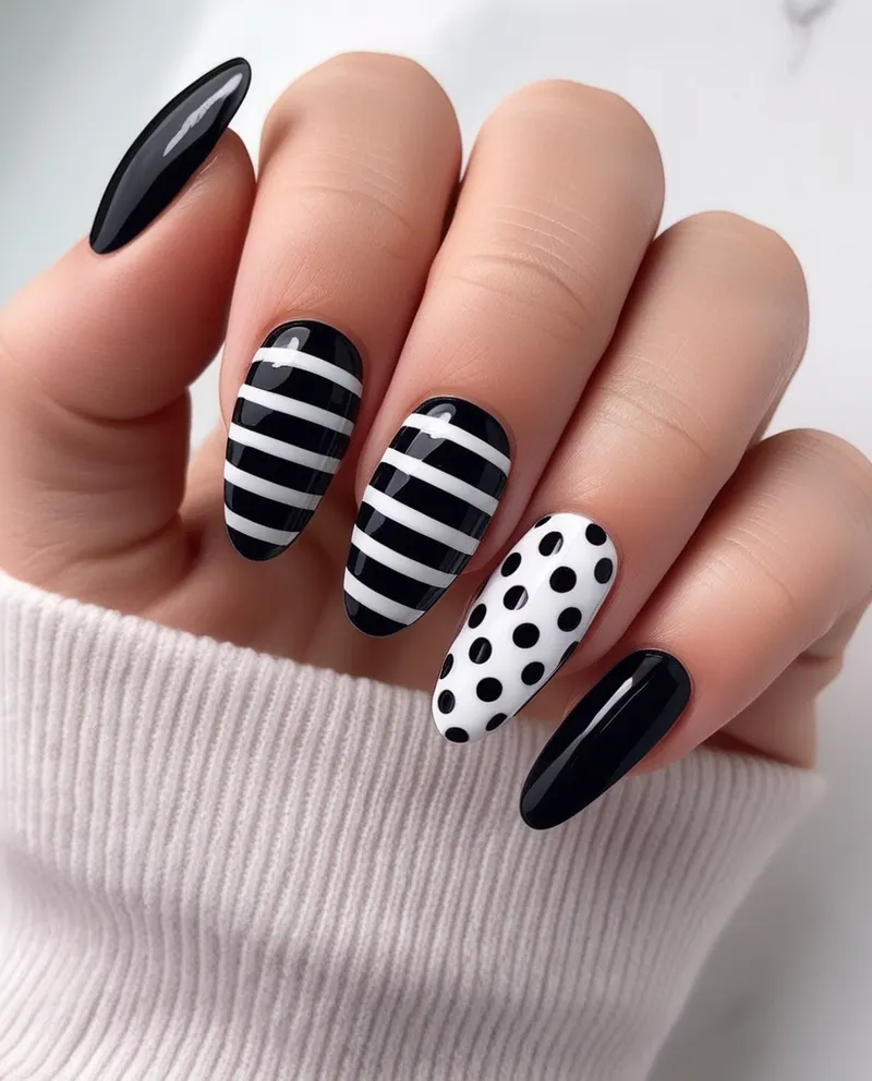 Chic black and white nails with stripes and polka dots.