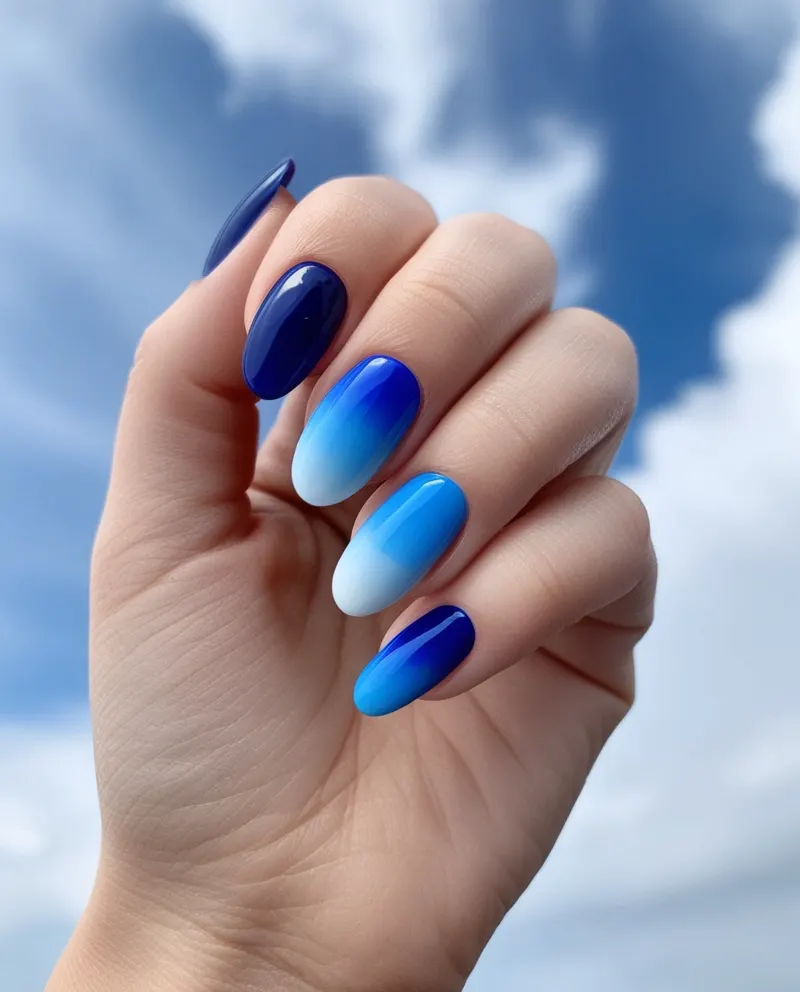 Ombré blue nails with a soft and romantic gradient effect.