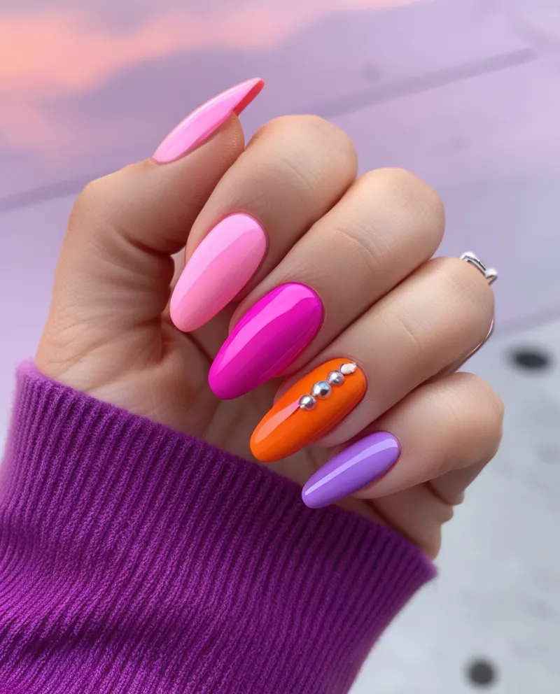 Sunset nails with a gradient of pink, orange, and purple hues.