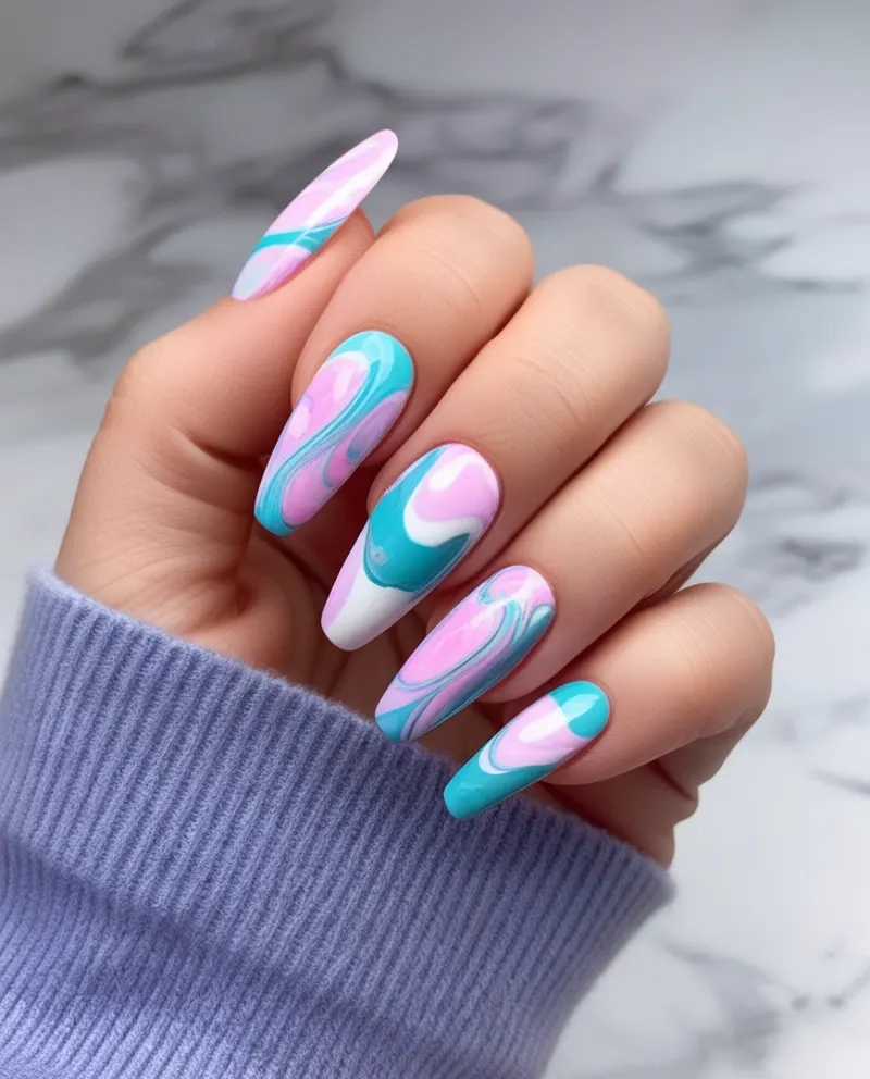 Marbled French tip nails with a swirling blend of colors for a unique twist.