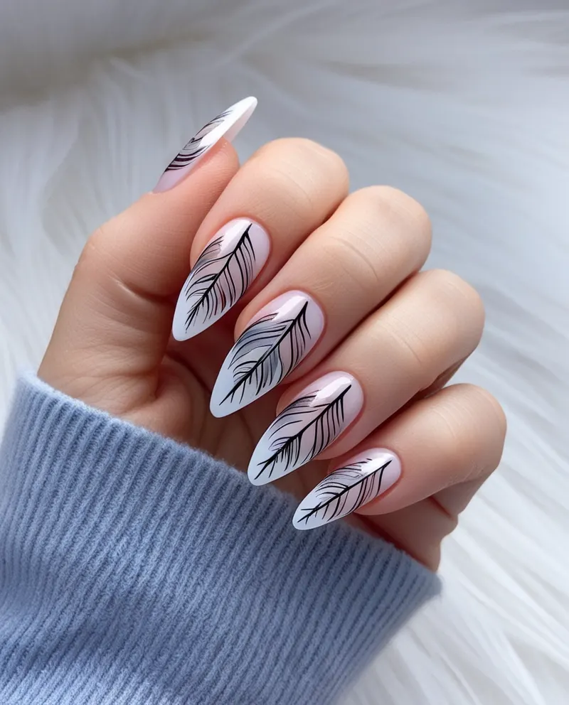 Elegant feather nail designs with detailed patterns for a soft, delicate look.