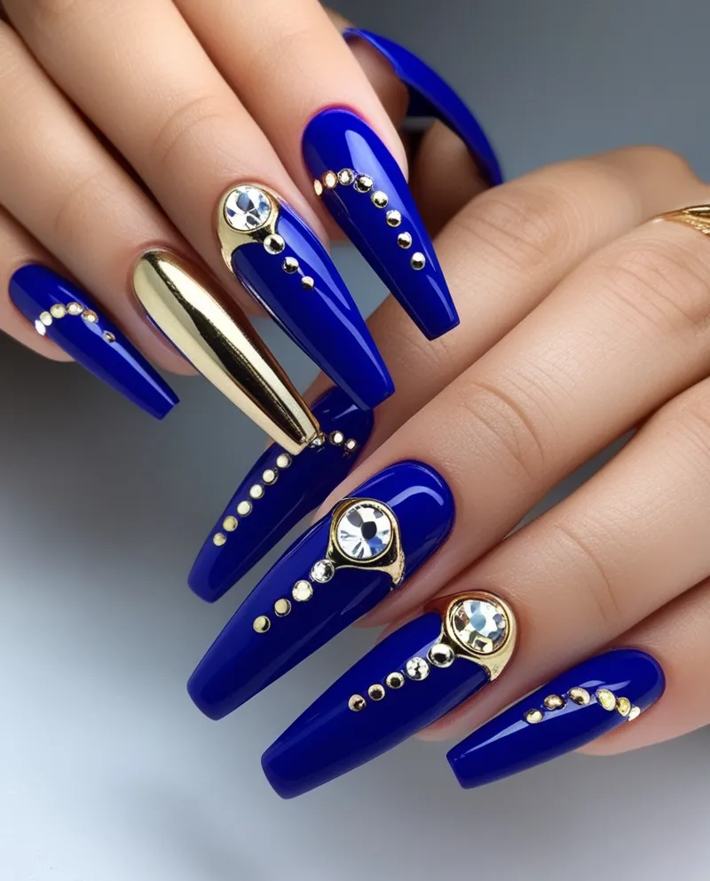 Elegant Royal Blue Nail Designs with gold accents and rhinestones.