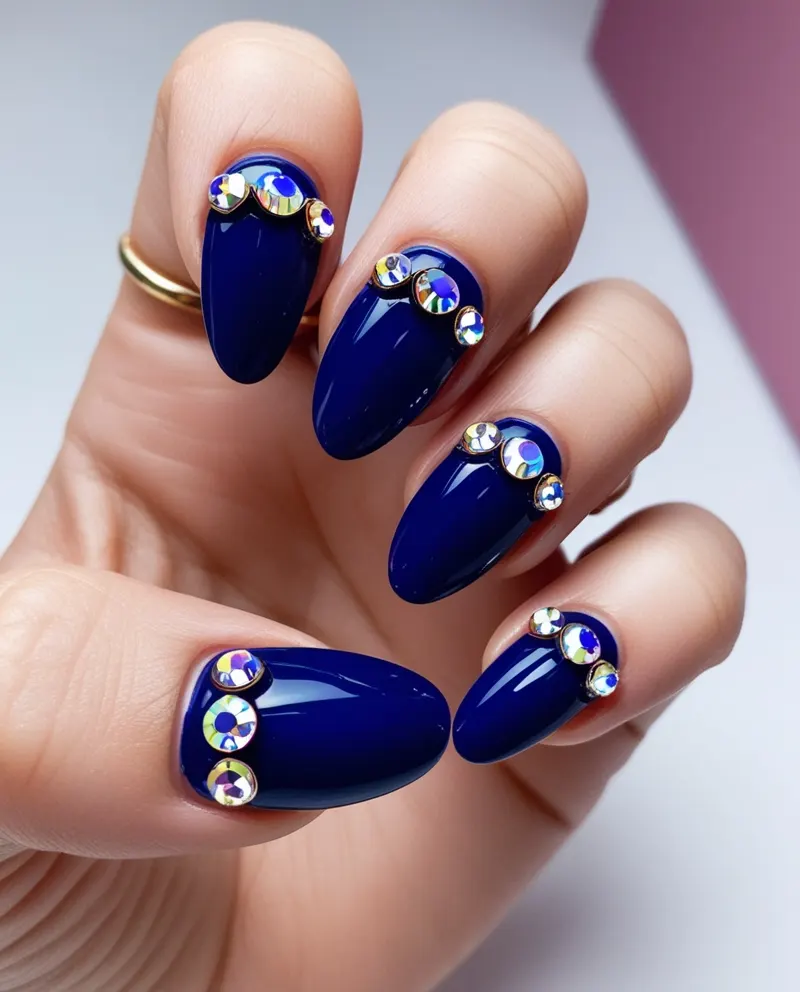 Blue nails decorated with sparkling rhinestones for a glamorous look.